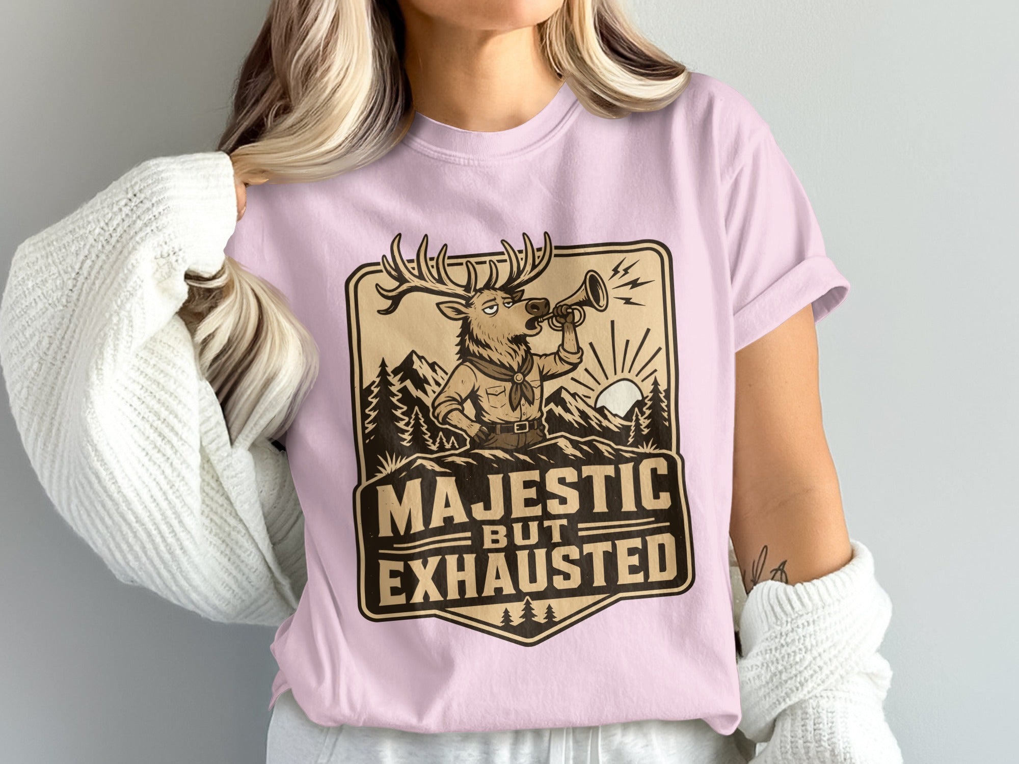 Deer in scout uniform blowing a horn with text "Majestic But Exhausted".