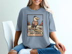 Eagle wearing a hat and striped shirt on a surfboard with text.