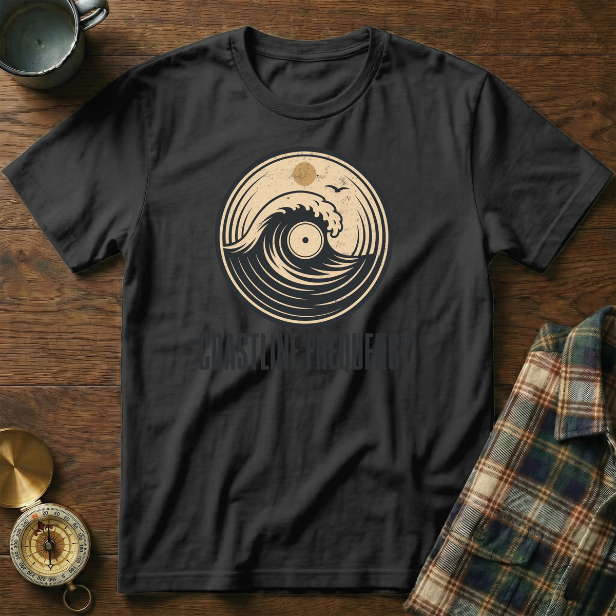 Black t-shirt with vinyl record wave graphic and text "COASTLINE FREQUENCY".