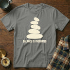 Grey t-shirt with a stacked stone design and the text "BALANCE IS OVERRATED".