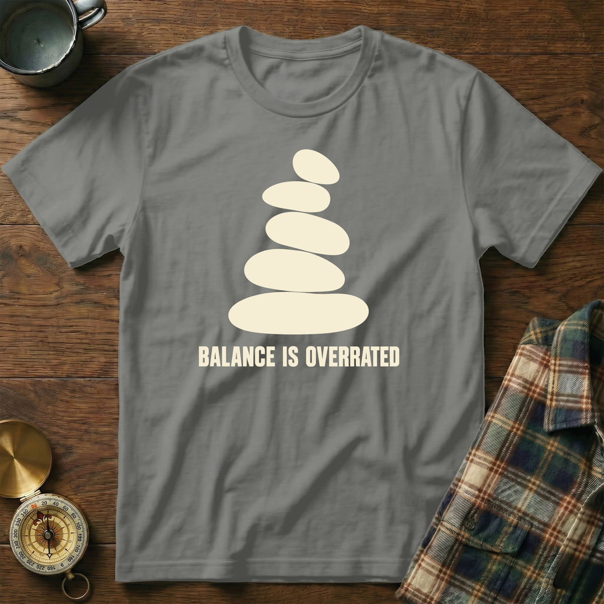 Grey t-shirt with a stacked stone design and the text "BALANCE IS OVERRATED".