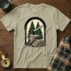 T-shirt with ax and firewood graphic framed by trees and an arch.