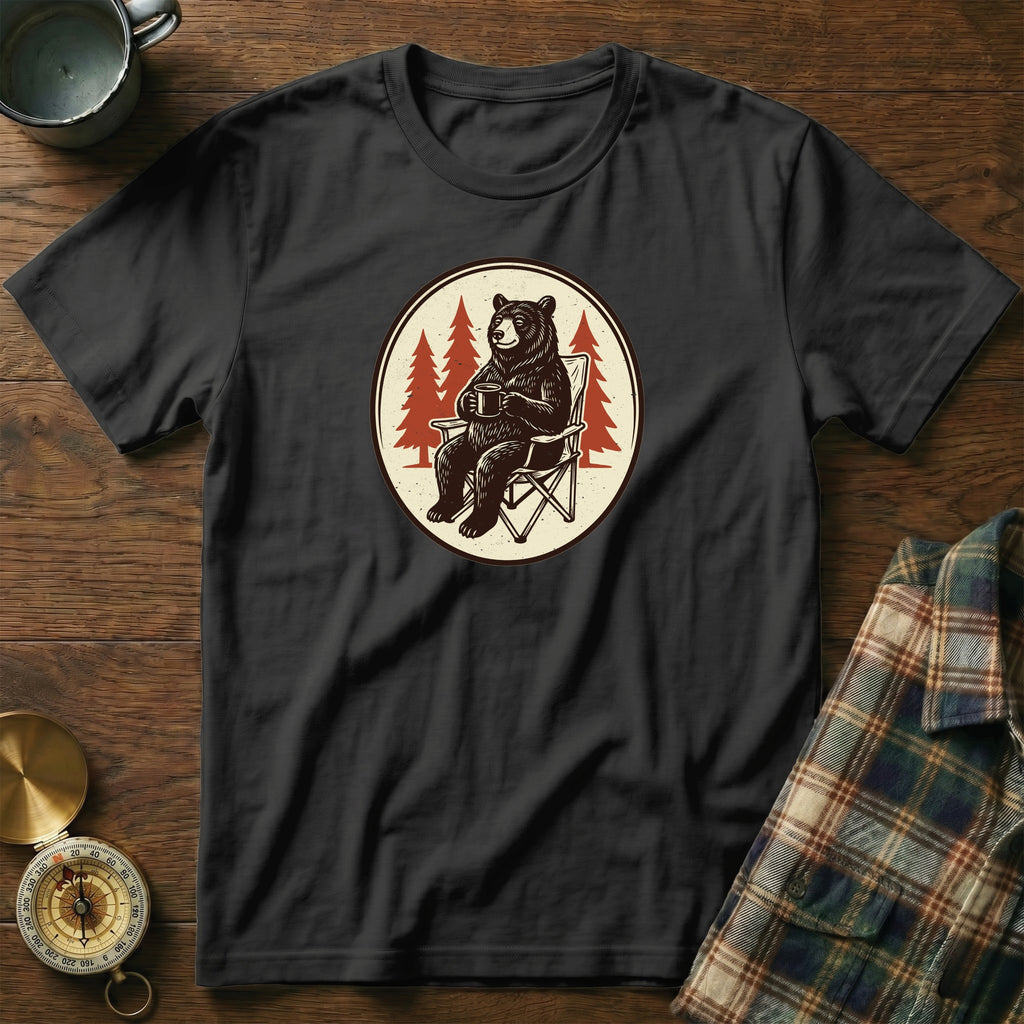 Black t-shirt with a circular graphic of a bear sitting in a camping chair with a mug.