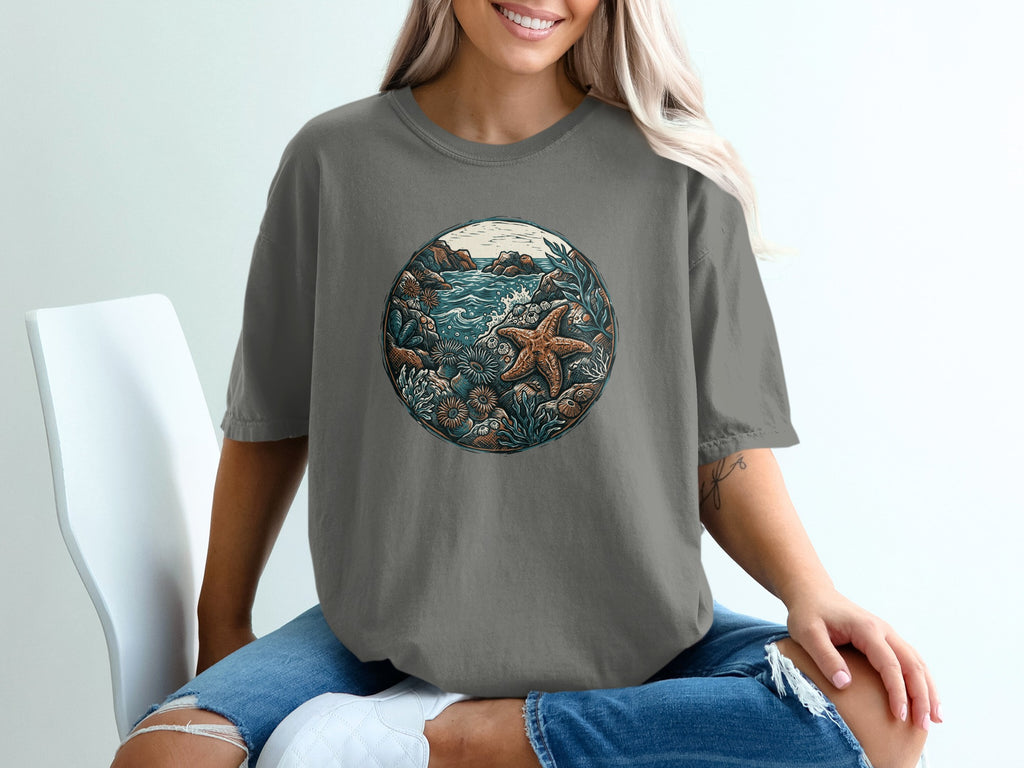 Graphic t-shirt with a circular ocean scene featuring starfish and coral.