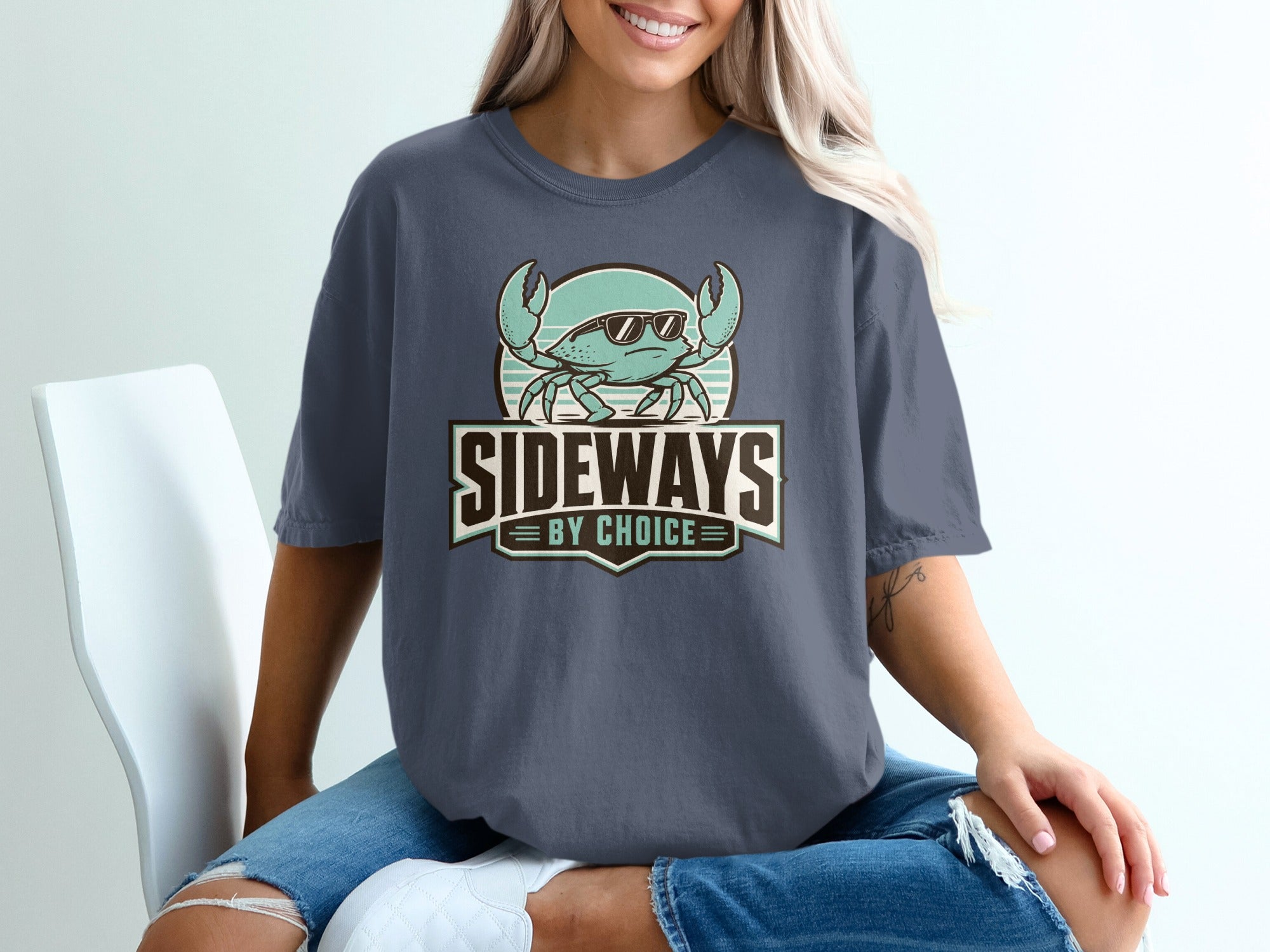 Crab wearing sunglasses with text "SIDEWAYS BY CHOICE" on a dark t-shirt.