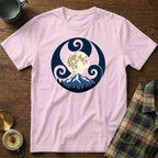 Pink t-shirt with moon, mountains, and trees graphic in dark blue circle.