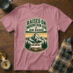 Pink t-shirt with "Raised on Mountain Air & AM Radio" graphic featuring mountains and camper van.