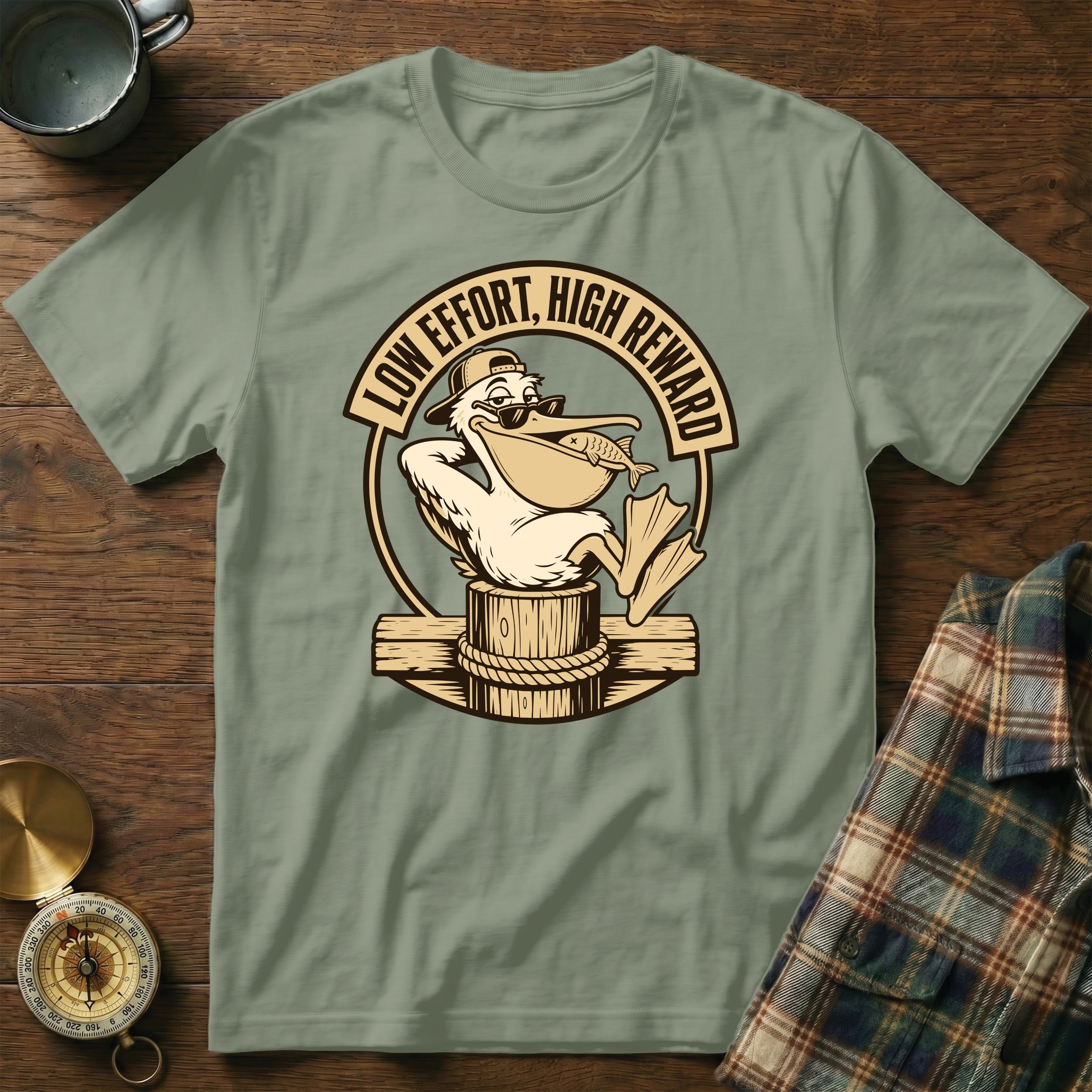 T-shirt with a cartoon pelican wearing sunglasses catching a fish, text says "Low Effort, High Reward".