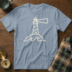Light blue t-shirt with a cream outline of a lighthouse on waves.