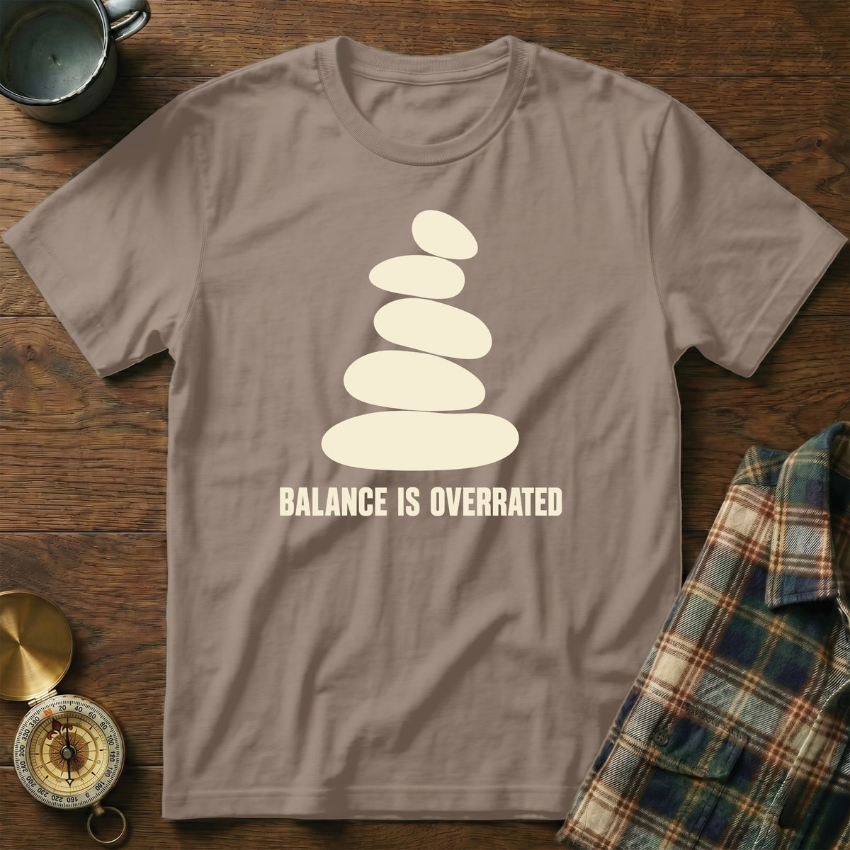 T-shirt with balanced stones and text "BALANCE IS OVERRATED".