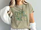 Tan t-shirt with "FISH 1 ME 0" and fish skeleton graphic.