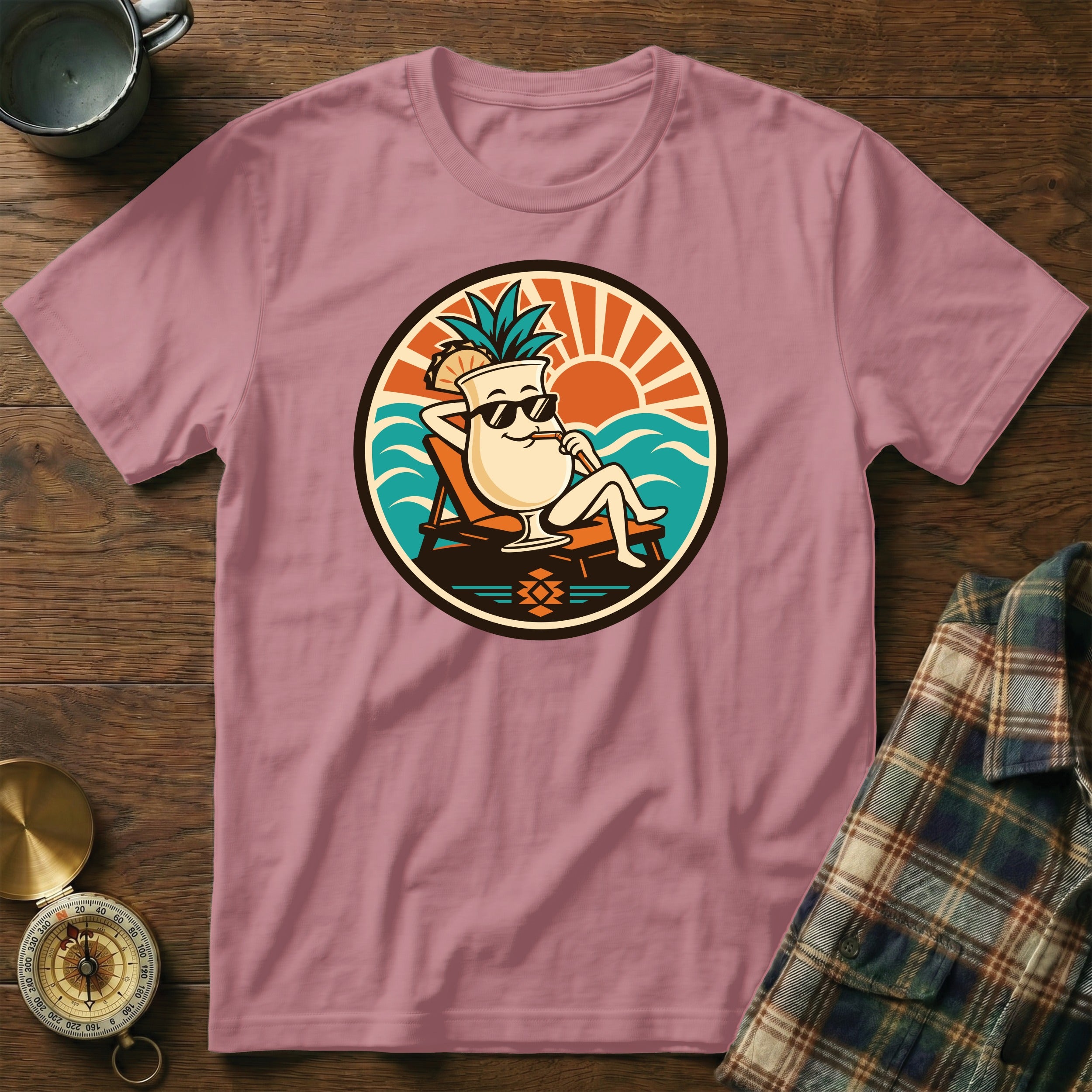 Pink t-shirt with cartoon cocktail relaxing on a beach chair.