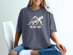 T-shirt with graphic of turtle carrying a backpack and text "ON MY WAY".