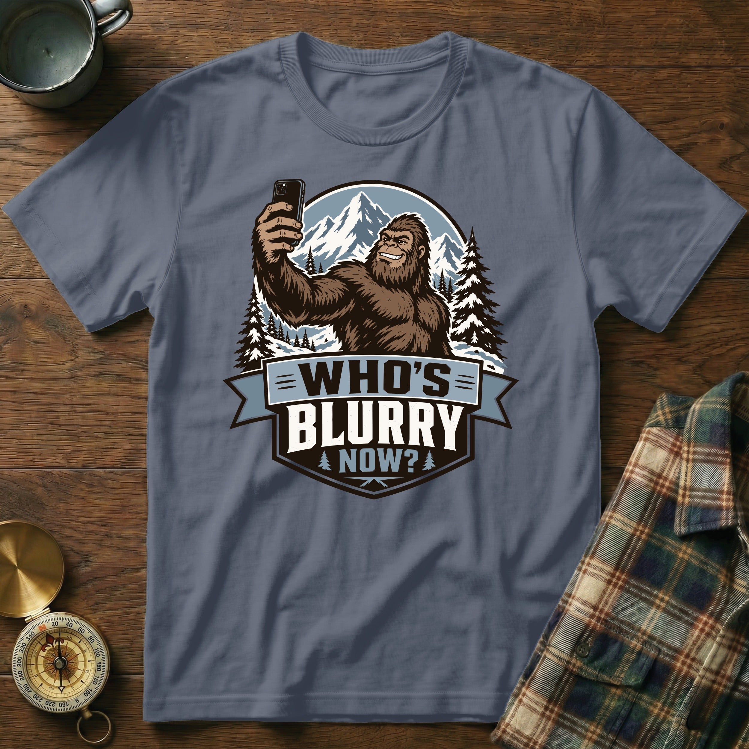 Bigfoot taking a selfie in mountains with text "WHO'S BLURRY NOW?"