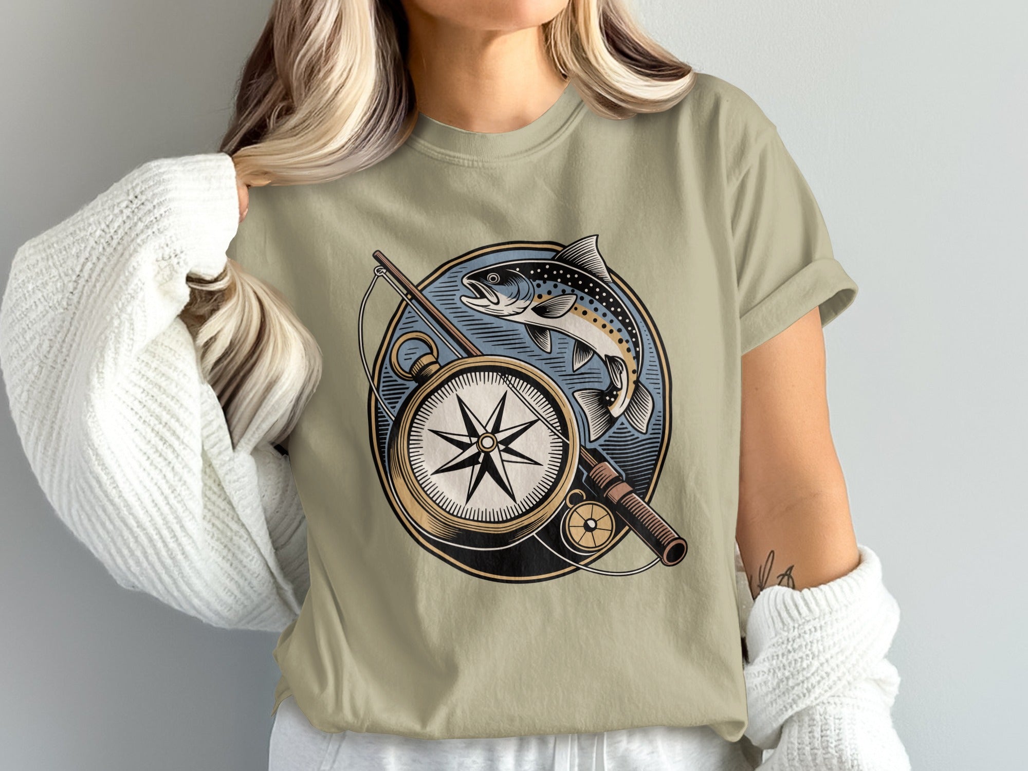 T-shirt with circular design of compass, fishing rod, and leaping fish.