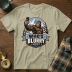 T-shirt graphic of Bigfoot taking a selfie with mountains and text "WHO'S BLURRY NOW?".
