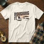 White t-shirt with "ROUGHING IT." text and a beach scene graphic.