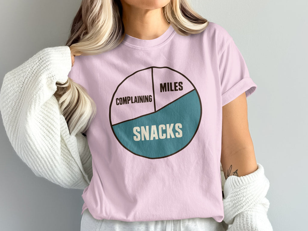 Pink t-shirt with pie chart graphic reading "Complaining", "Miles", and "Snacks".
