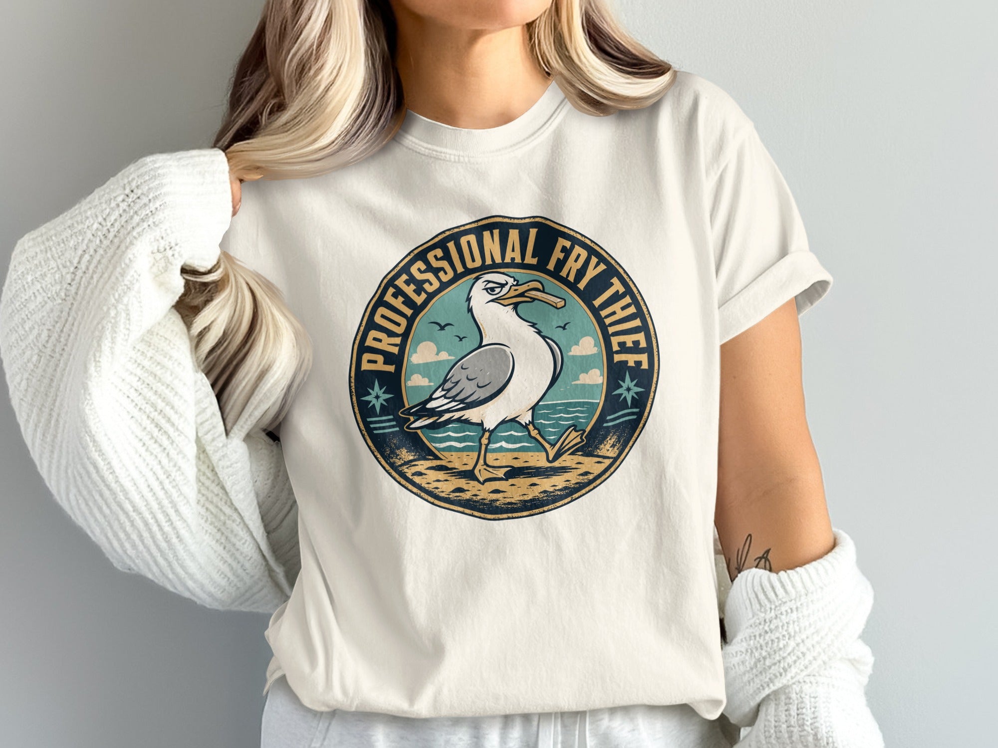 Circular graphic with seagull holding french fry and text "PROFESSIONAL FRY THIEF".