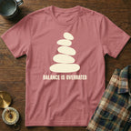 Rose t-shirt with stacked stones graphic and "BALANCE IS OVERRATED" text.