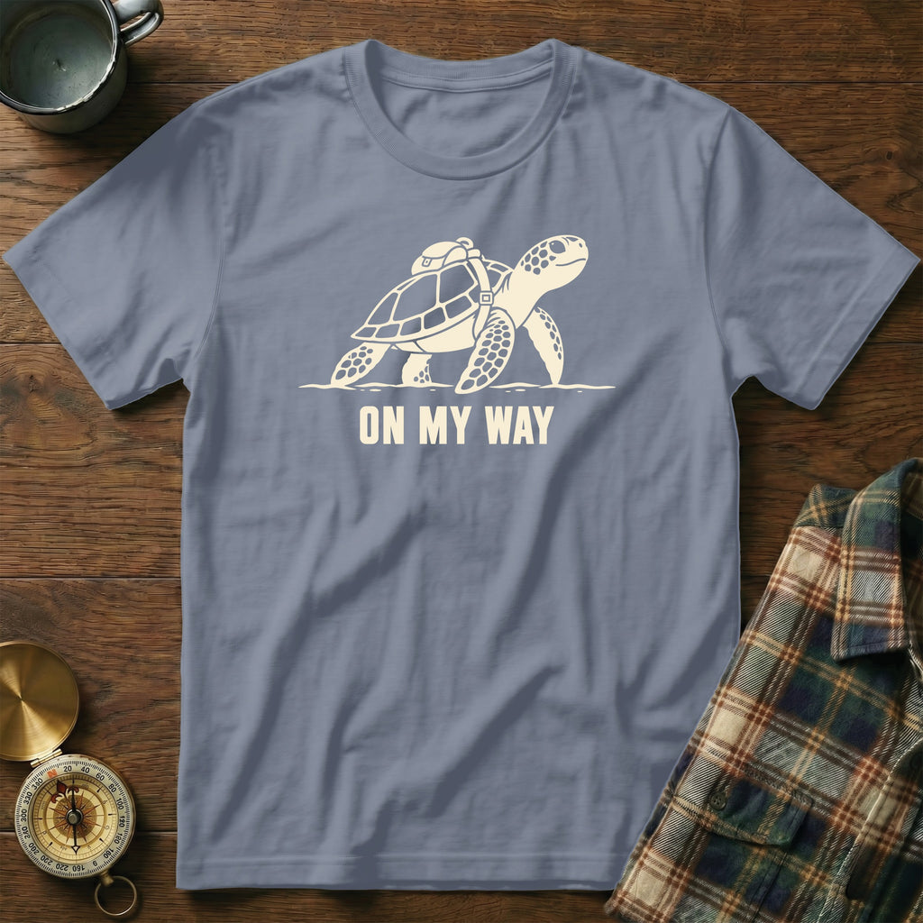 T-shirt with a graphic of a turtle wearing a backpack and the text "ON MY WAY".