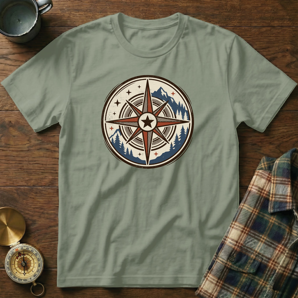 Light sage t-shirt with a compass and mountain graphic on the chest.