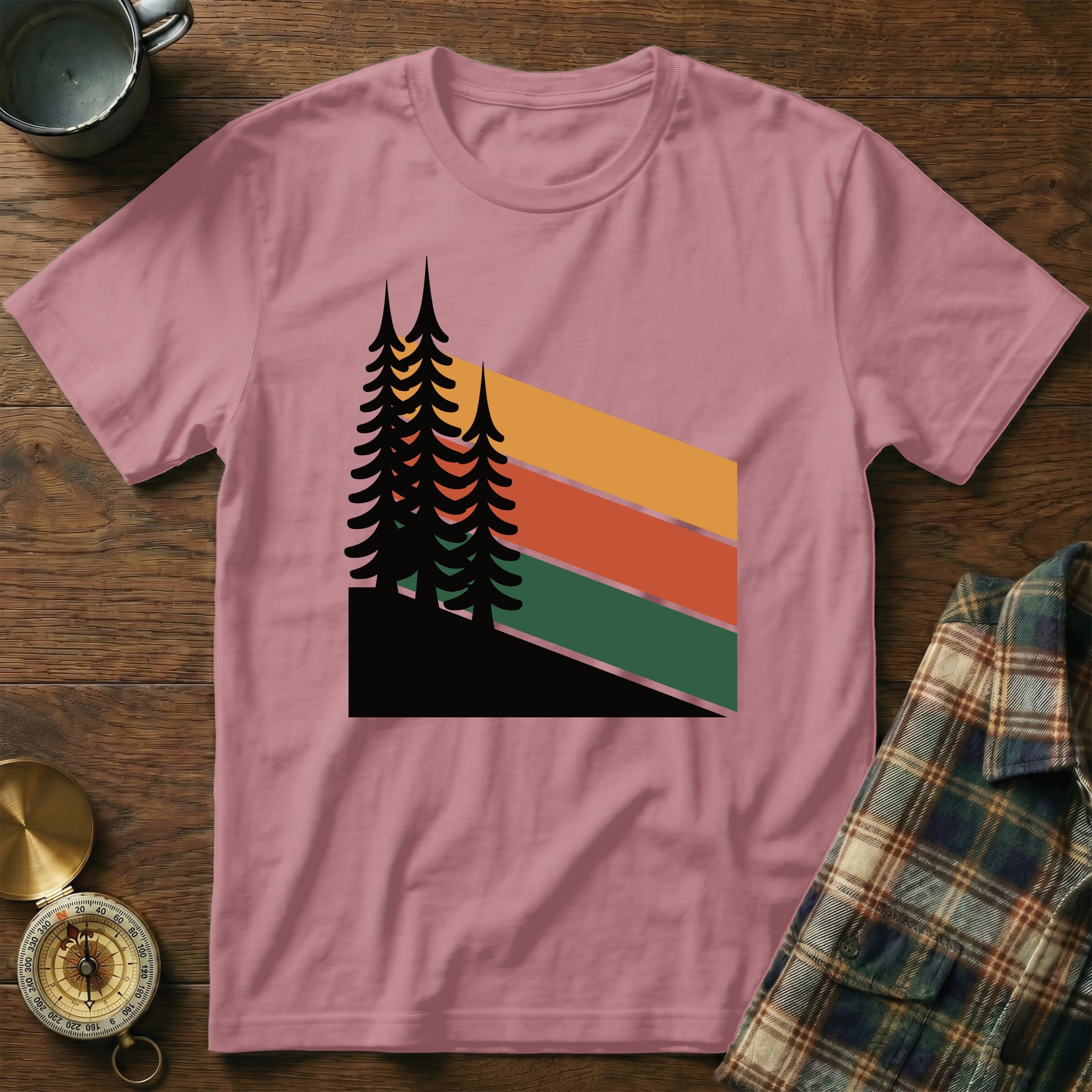 Pink t-shirt with a retro forest graphic and stripes.