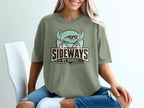 Green t-shirt with a cartoon crab wearing sunglasses and text "SIDEWAYS BY CHOICE".