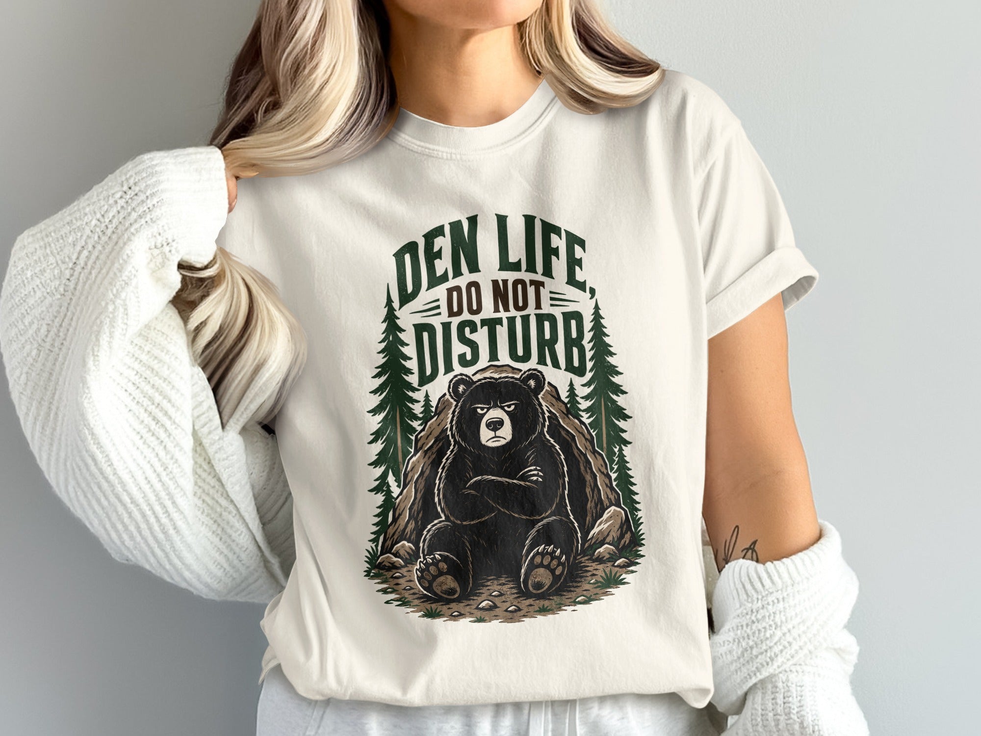 T-shirt graphic with text "Den Life Do Not Disturb" and a grumpy bear.