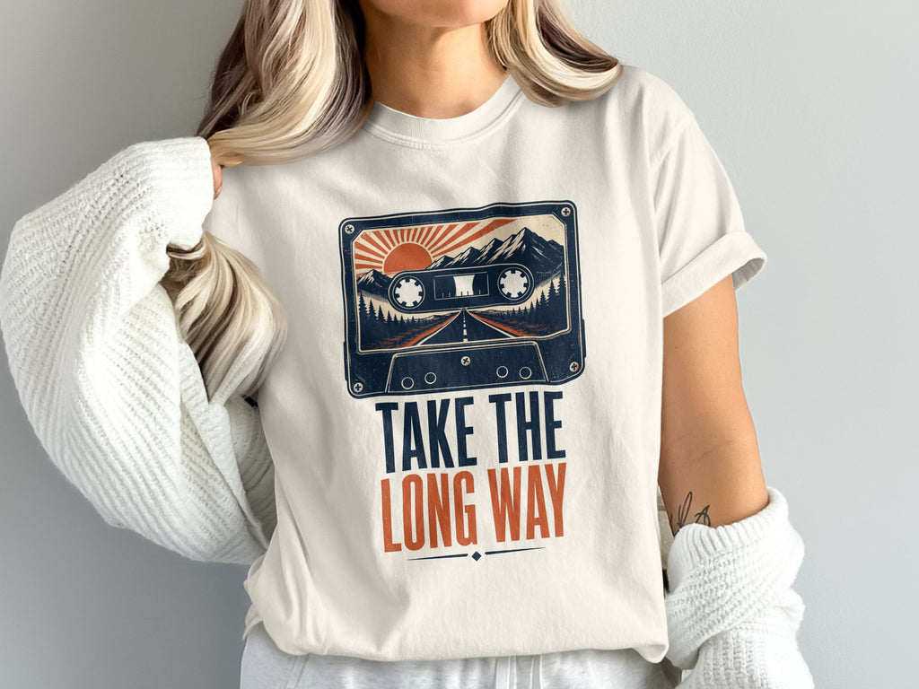 Graphic t-shirt with cassette tape, mountains, road, sun, and text "TAKE THE LONG WAY".
