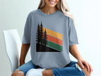 T-shirt with abstract forest and striped mountain design.