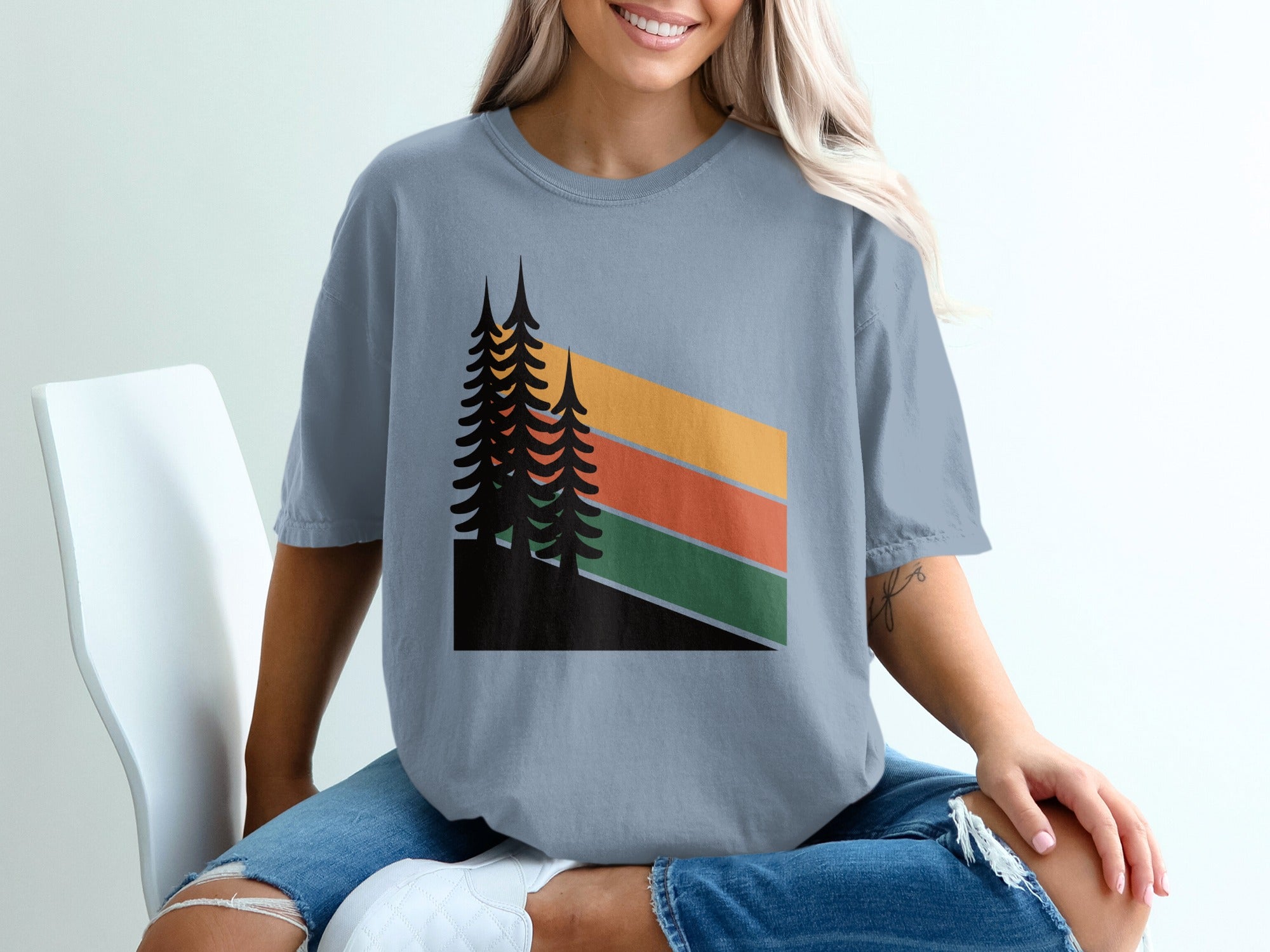 T-shirt with abstract forest and striped mountain design.