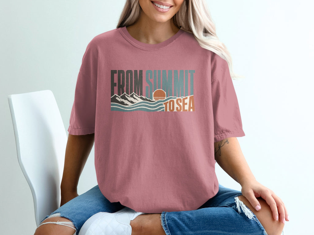Pink t-shirt with "FROM SUMMIT TO SEA" text and mountain-wave graphic.