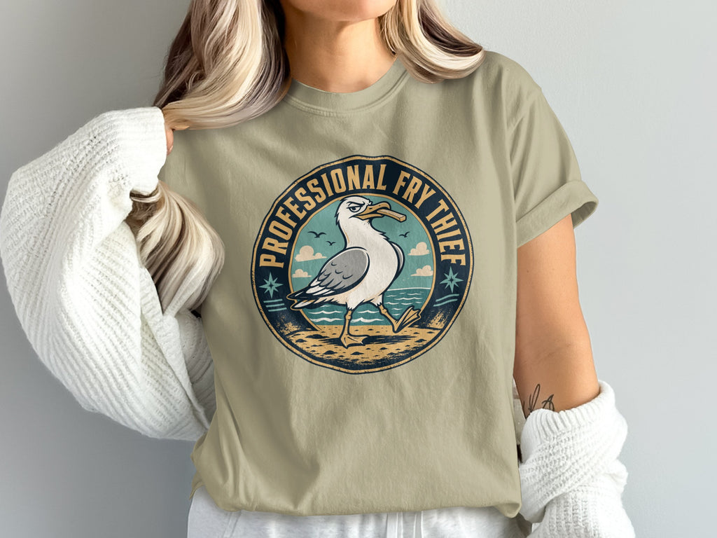 T-shirt graphic of a seagull holding a fry with text "PROFESSIONAL FRY THIEF".