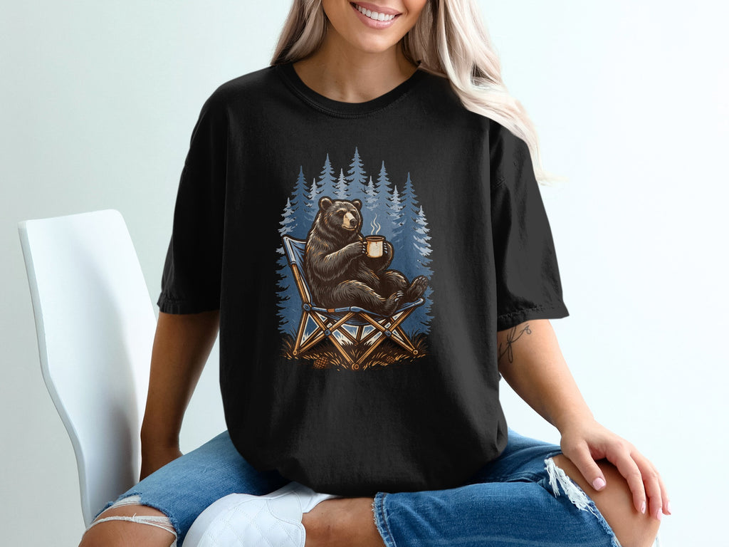 Bear sitting in a camping chair with a hot mug, surrounded by pine trees.