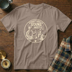 T-shirt with a cartoon turtle wearing a hard hat and giving a thumbs up, next to a sandcastle.