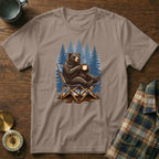 Bear relaxing in a chair with coffee, forest background graphic on t-shirt.