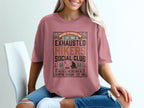 Pink t-shirt with "Exhausted Hikers Social Club" graphic and campfire scene.