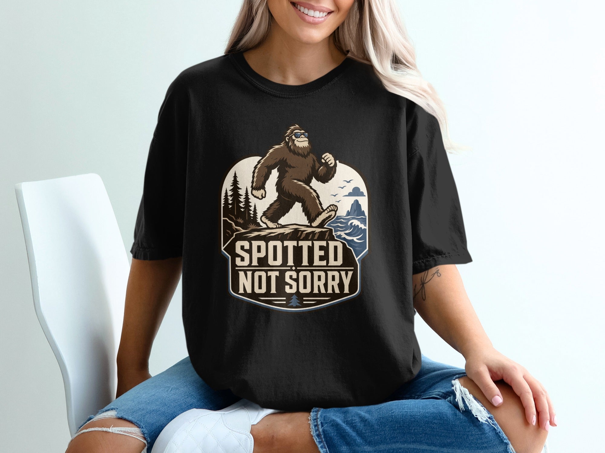 Bigfoot wearing sunglasses walking on a cliff with the text "Spotted Not Sorry".