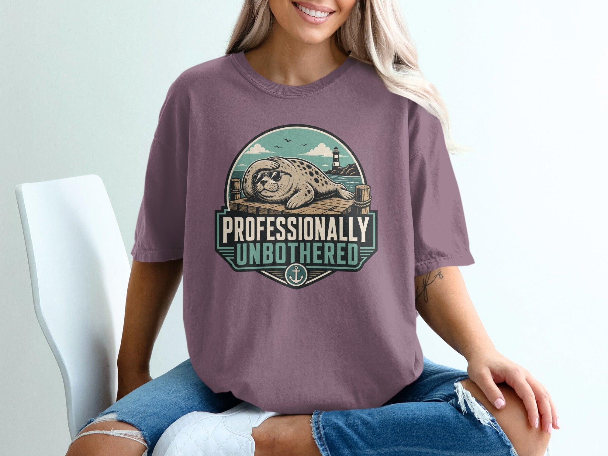 Seal wearing sunglasses on a dock with text "PROFESSIONALLY UNBOTHERED".