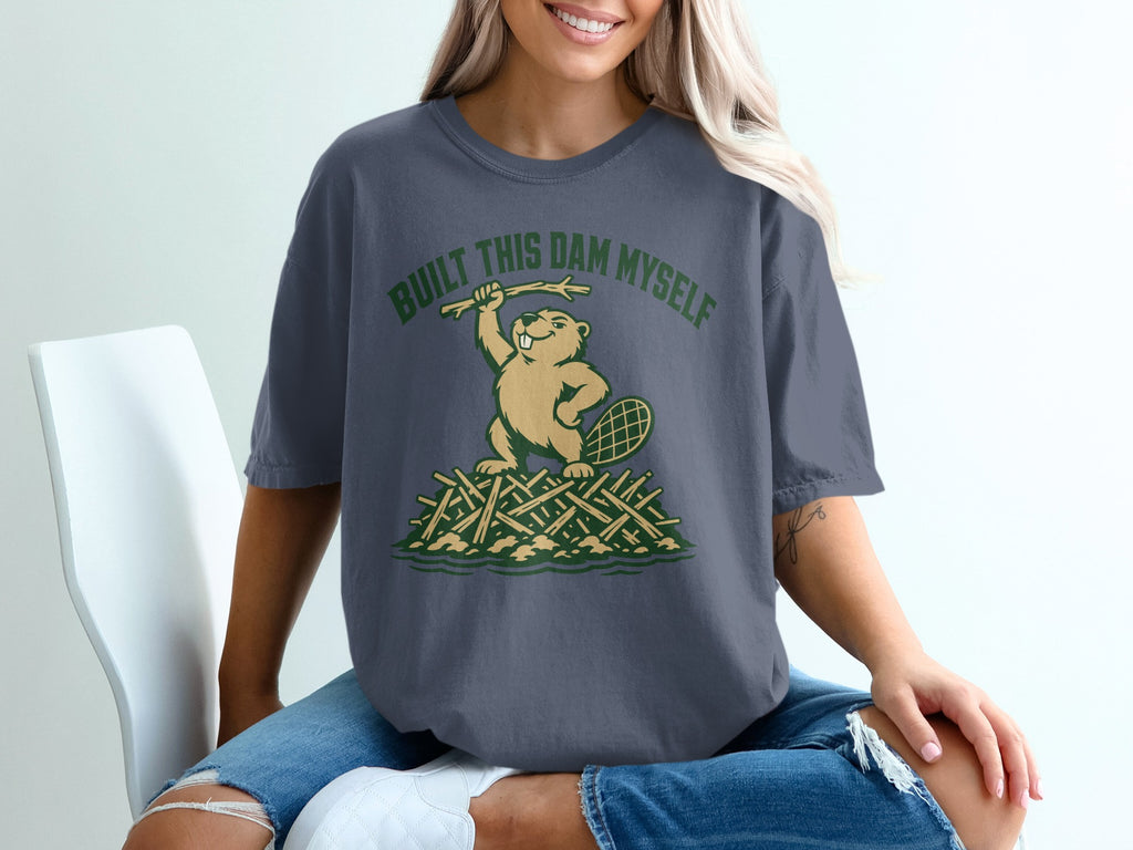 Beaver holding stick atop dam with text "BUILT THIS DAM MYSELF."