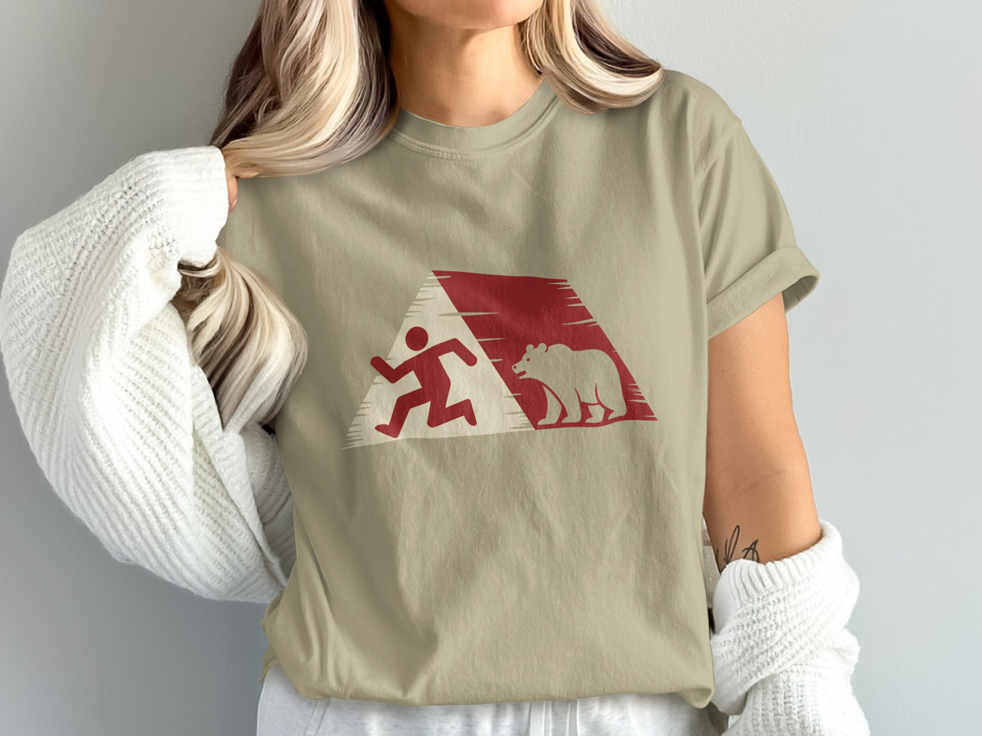 T-shirt with red graphic of a running person and a bear.