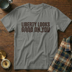 Gray t-shirt with "Liberty Looks Good On You" text above mountain graphic.