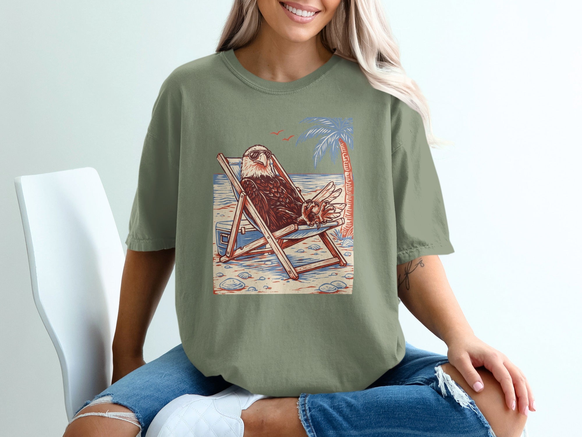 Eagle wearing sunglasses lounging in a beach chair with a palm tree.