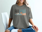 T-shirt with "From Summit to Sea" text and mountain and ocean graphic.