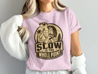 Turtle wearing sunglasses and holding a towel with text "Slow is the whole point".