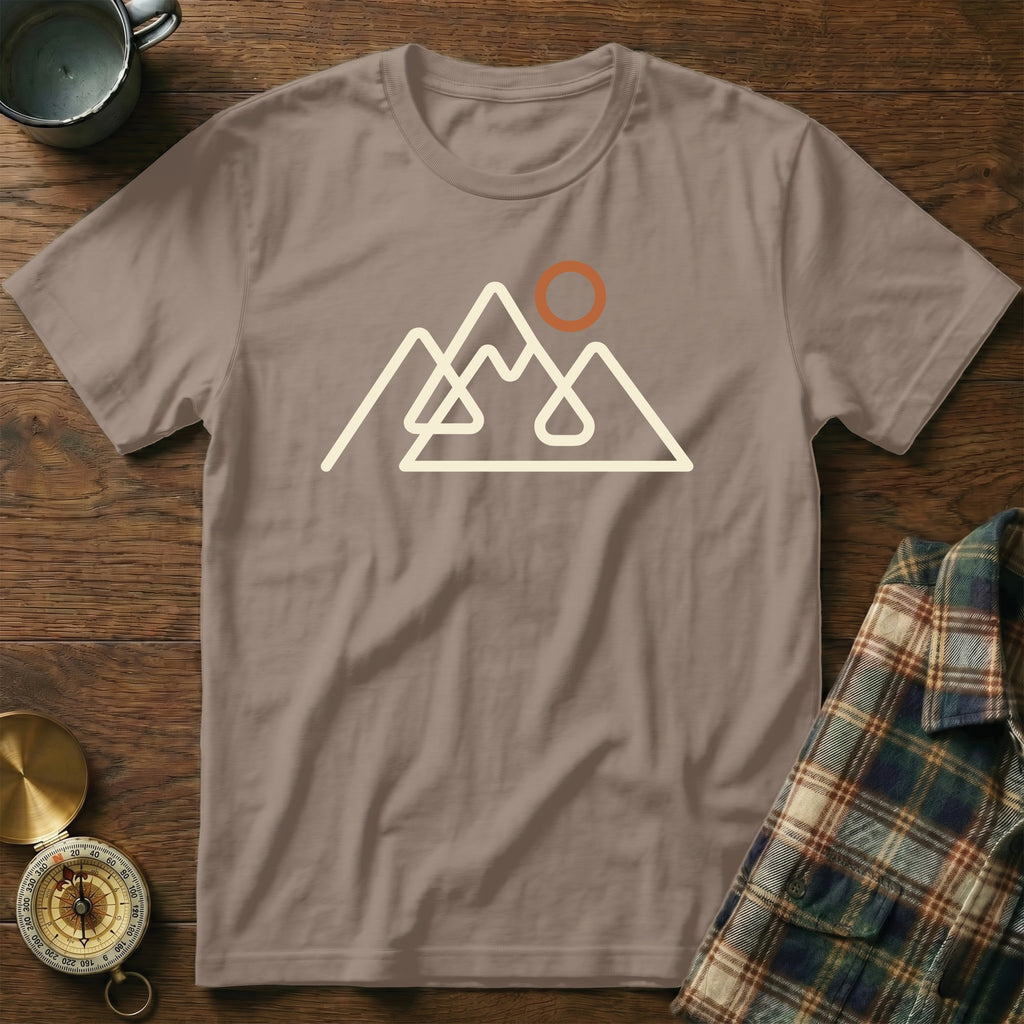 Brown t-shirt with a cream outline graphic of mountains and a sun.