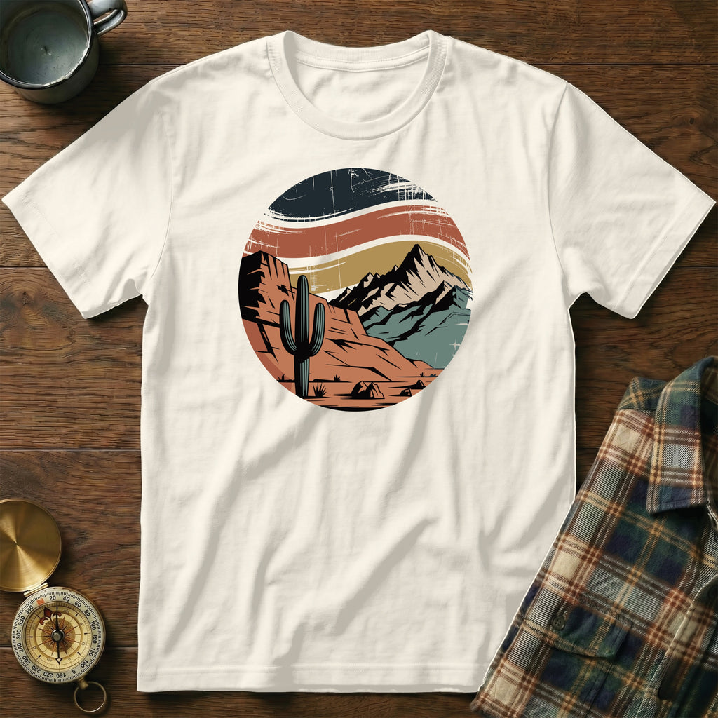 Cream t-shirt with circular desert landscape graphic featuring cactus and mountains.