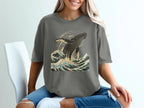 Gray t-shirt with a breaching whale and ocean waves graphic.