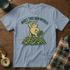Light blue t-shirt with a beaver on a dam and text "Built This Dam Myself".